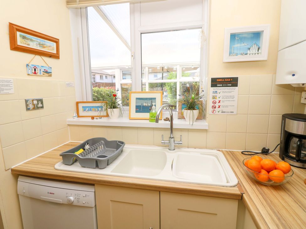 A kitchen with a sink and dishwasher at 32 Cranleigh Close Tuckton