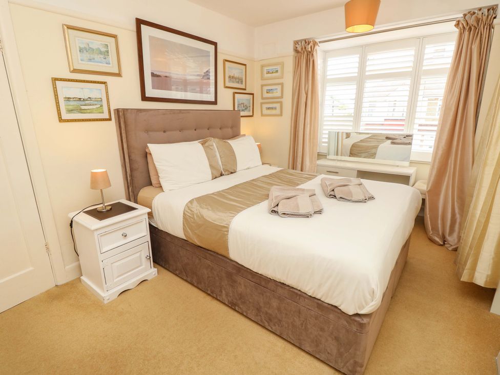 A bedroom with a bed and bedside table at 32 Cranleigh Close Tuckton