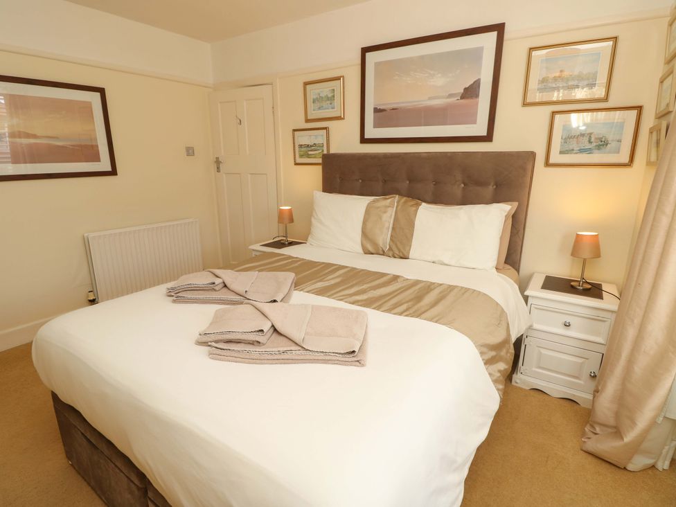 A bedroom with a bed and bedside table at 32 Cranleigh Close in Tuckton
