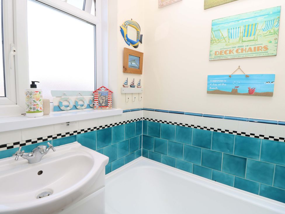 A bathroom with a sink and bathtub at 32 Cranleigh Close Tuckton