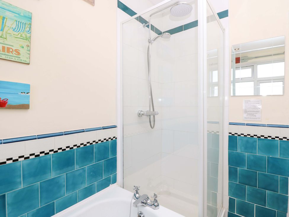 A bathroom with a shower and bathtub at 32 Cranleigh Close in Tuckton