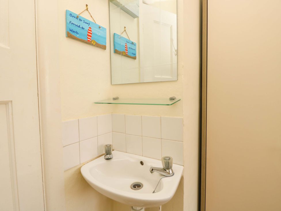 A bathroom with a sink and mirror at 32 Cranleigh Close Tuckton