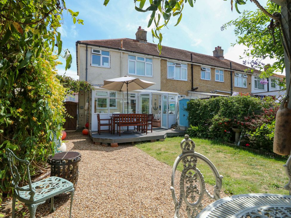A garden with a patio table and chairs at 32 Cranleigh Close in Tuckton
