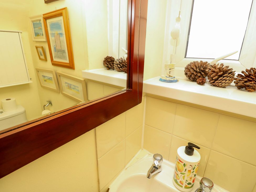 A bathroom with a sink and decorative elements at 32 Cranleigh Close Tuckton