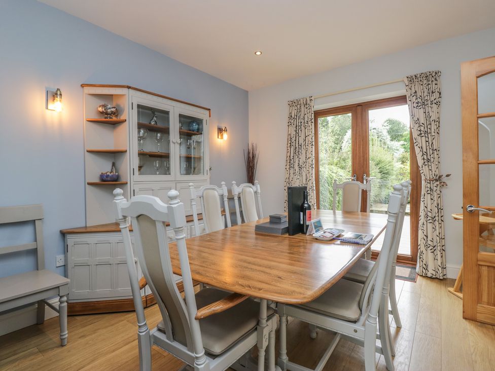 A dining room with a table and chairs at Langtree Arnside