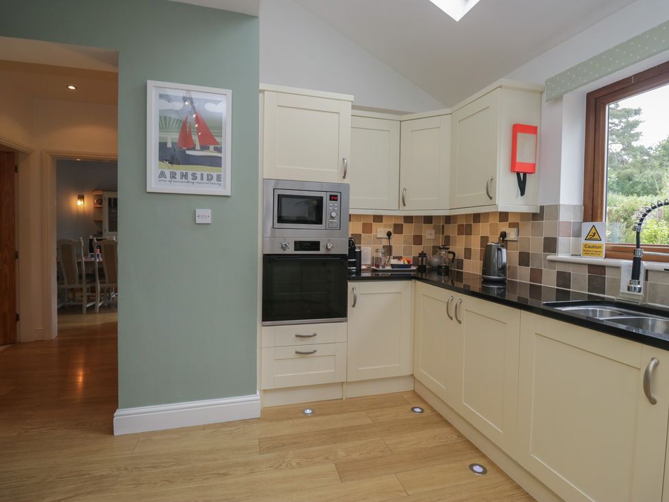 A kitchen with cabinets and appliances at Langtree in Arnside