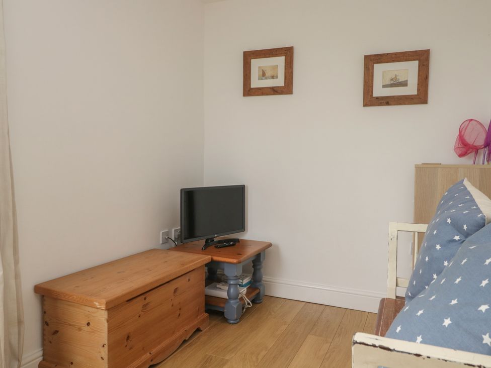 A living room with a television and furniture at Langtree in Arnside