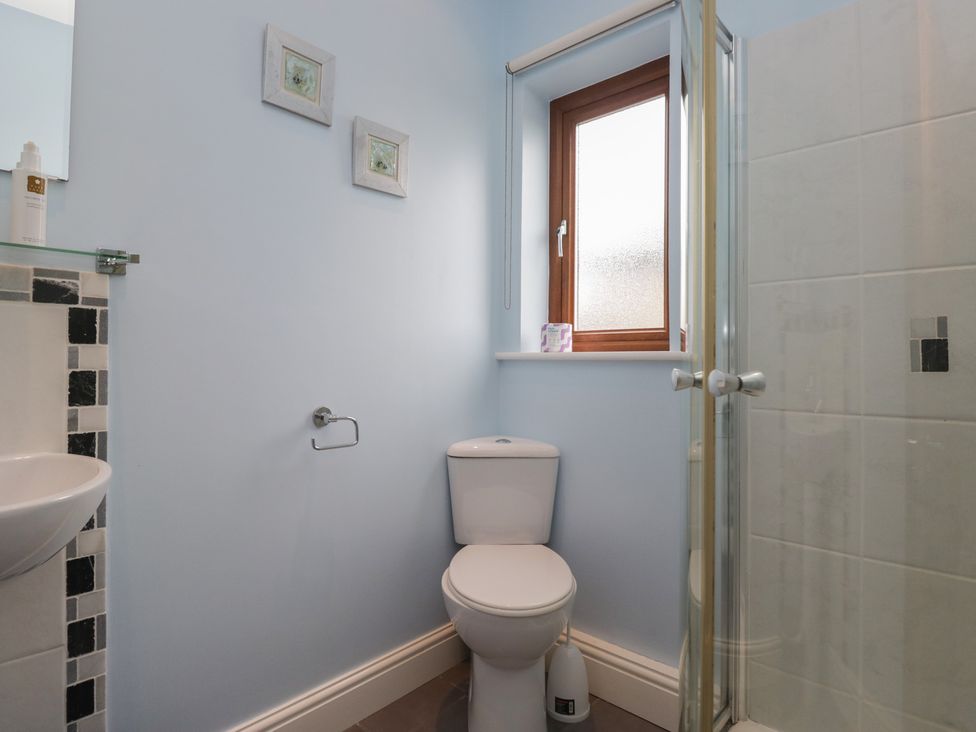 A bathroom with a sink and shower at Langtree in Arnside