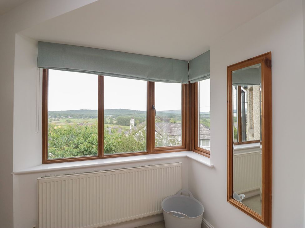 A room with a window and a mirror at Langtree in Arnside