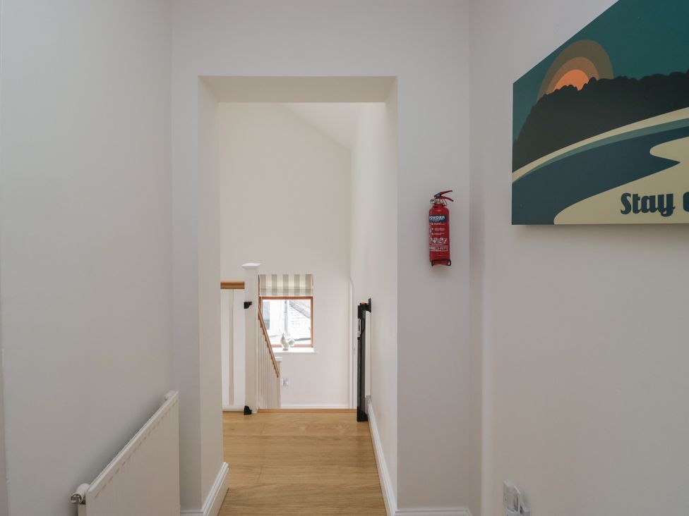 A hallway with staircase and window at Langtree in Arnside