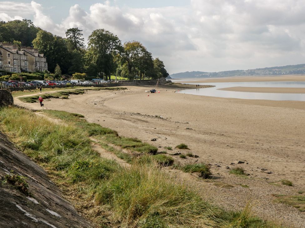 A beach scene with water and buildings at Langtree in Arnside