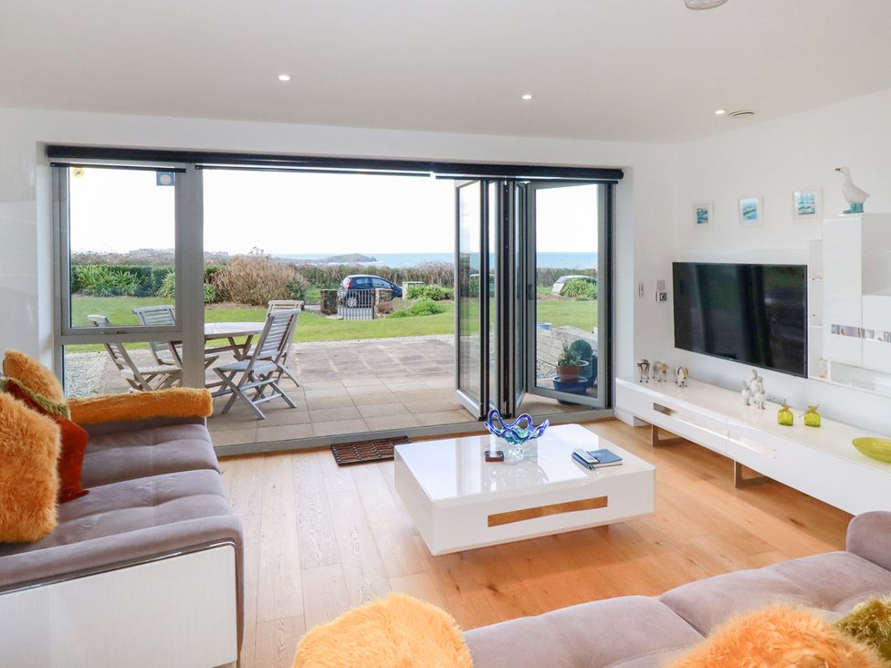 A living room with a sliding door open to a patio at Apartment no.21 in Newquay