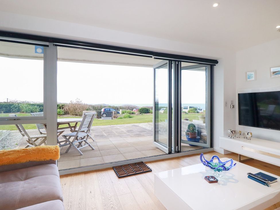 A living room with a glass door leading to a patio at Apartment no.21 in Newquay