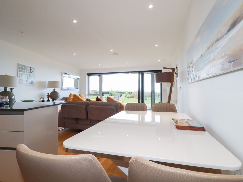 A dining area with a table and chairs at Apartment no.21 Newquay