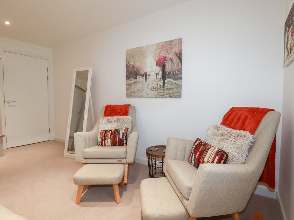 A living room with armchairs and a side table at Apartment no.21 in Newquay