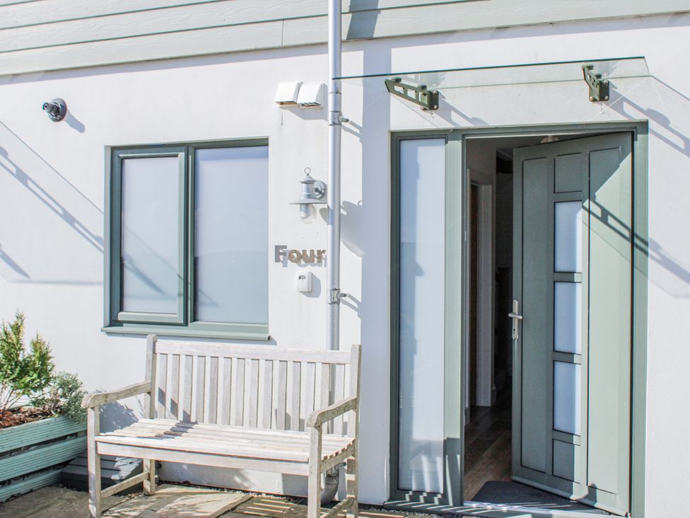 An entrance with a bench and door at 4 Ocean Reach in Bolberry