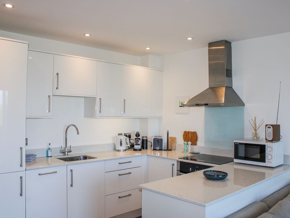 A kitchen with a sink, microwave, and coffee maker at 4 Ocean Reach in Bolberry