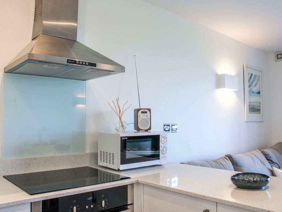 A kitchen with a microwave and stove at 4 Ocean Reach in Bolberry