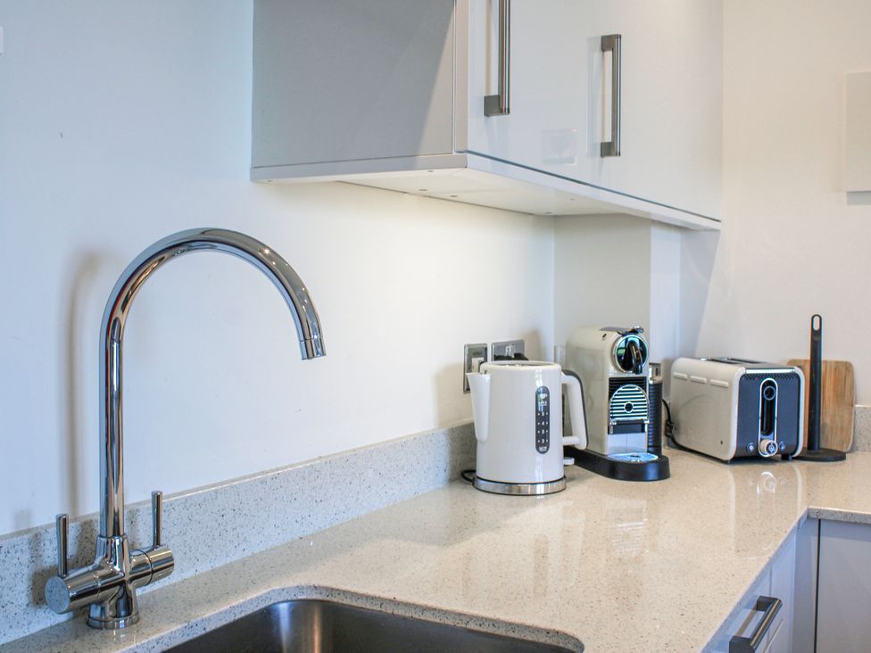 A kitchen with a sink, tap, kettle, coffee machine, and toaster at 4 Ocean Reach in Bolberry