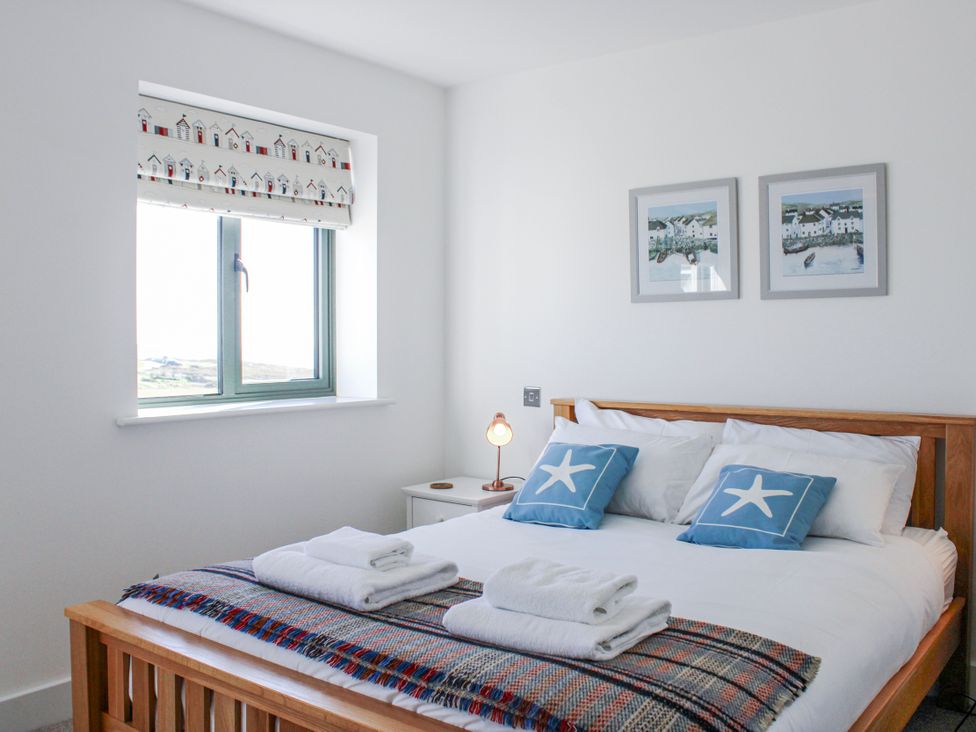 A bedroom with a bed and window at 4 Ocean Reach in Bolberry