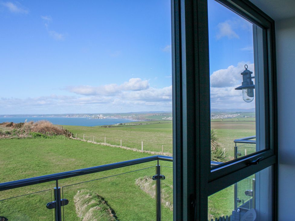 A view from a window showing grass and sea at 4 Ocean Reach Bolberry