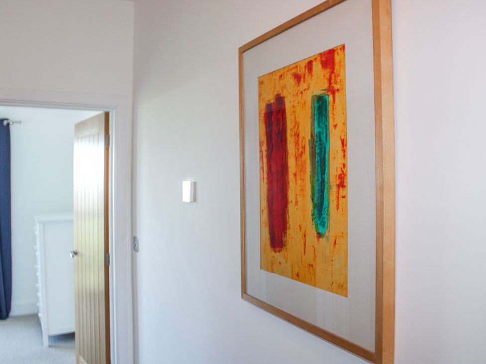 A hallway with a painting on the wall at 4 Ocean Reach in Bolberry