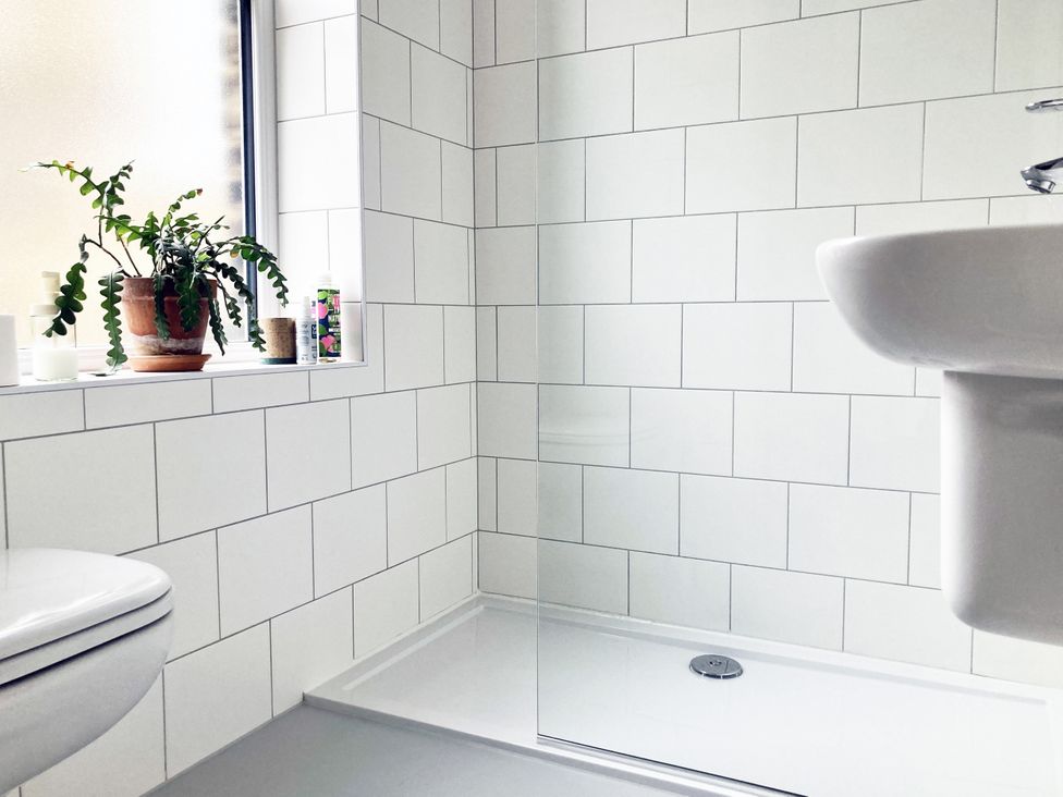 A bathroom with a shower and sink at The Old Riverside School House Apt 5 in Hebden Bridge