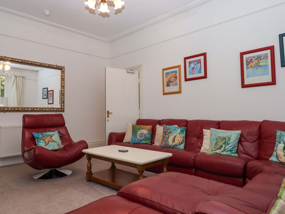 A living room with a sofa and armchair at Babbacombe Hall in Babbacombe