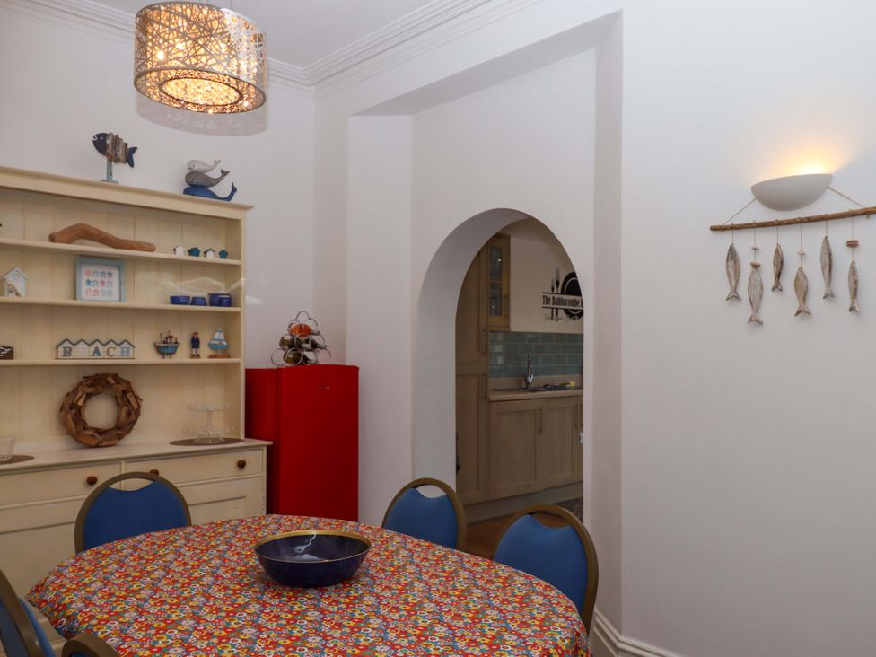 A dining room with a table and chairs at Babbacombe Hall Babbacombe