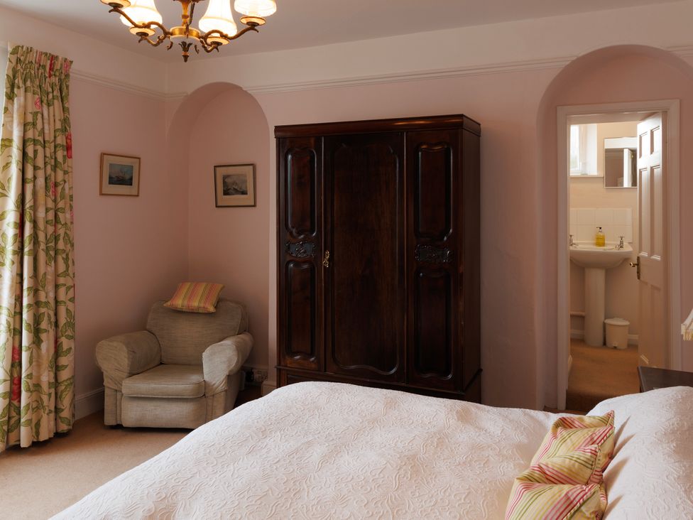 A bedroom with a bed and wardrobe at 18 Southtown in Dartmouth