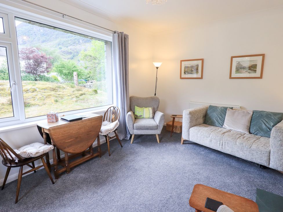 A living room with a sofa and armchair at Rock Cottage in Keswick