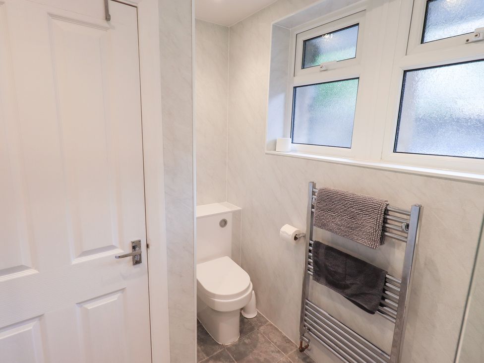 A bathroom with a toilet and towel radiator at Rock Cottage in Keswick