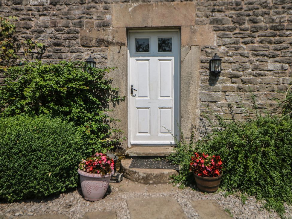 A white door with plants beside it at Slade House Ilam Staffordshire