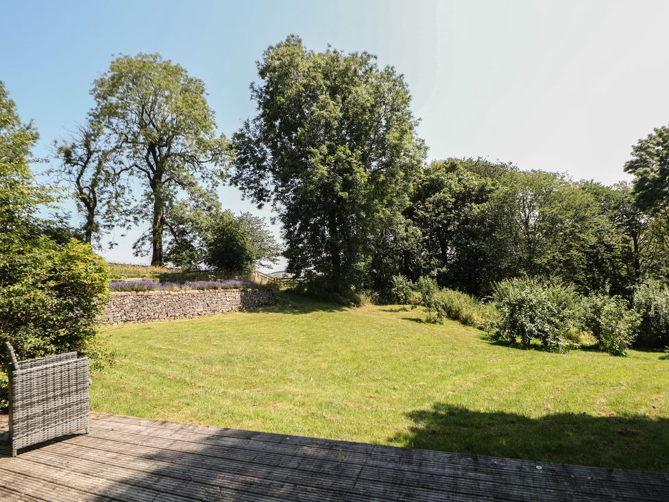 A garden with grass and trees at Slade House Ilam Staffordshire