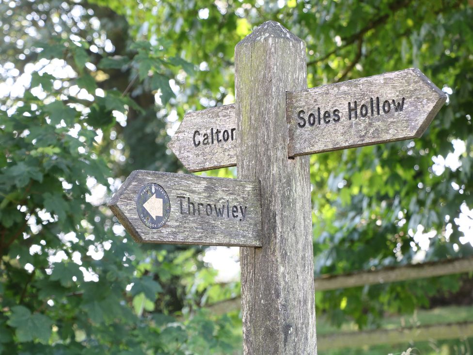 A signpost indicating directions to Calton, Soles Hollow, and Throwley at Slade House in Ilam, Staffordshire