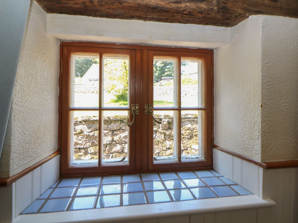 A window with a stone wall view at Slade Cottage in Ilam