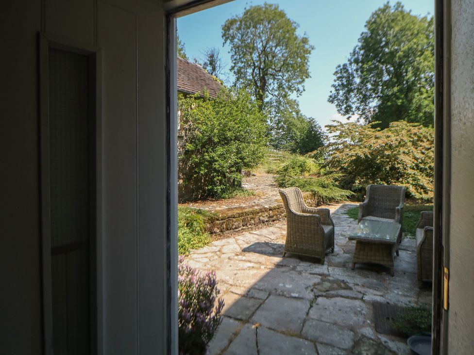 A patio with chairs and a table at Slade Cottage Ilam