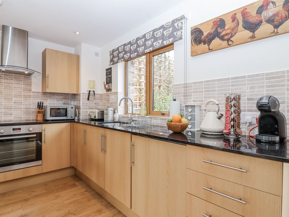 A kitchen with a sink and appliances at Whitsand in Tideford