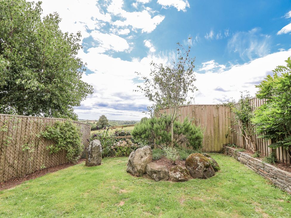 A garden with trees and rocks at Whitsand in Tideford
