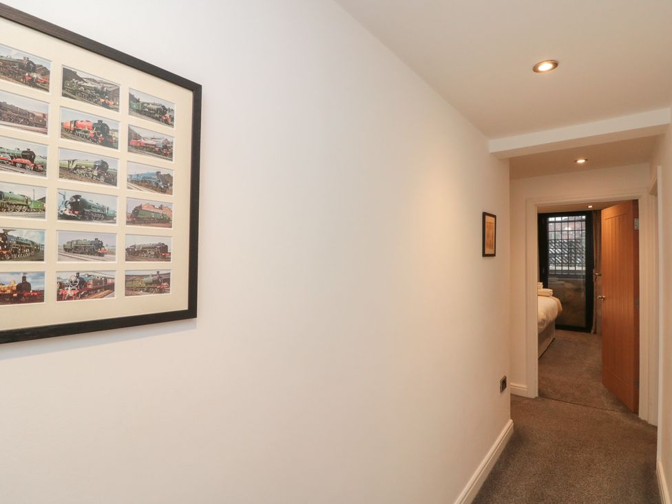 A hallway with framed pictures on the wall at Sir Nigel Gresley @ Engine Shed in Whitby