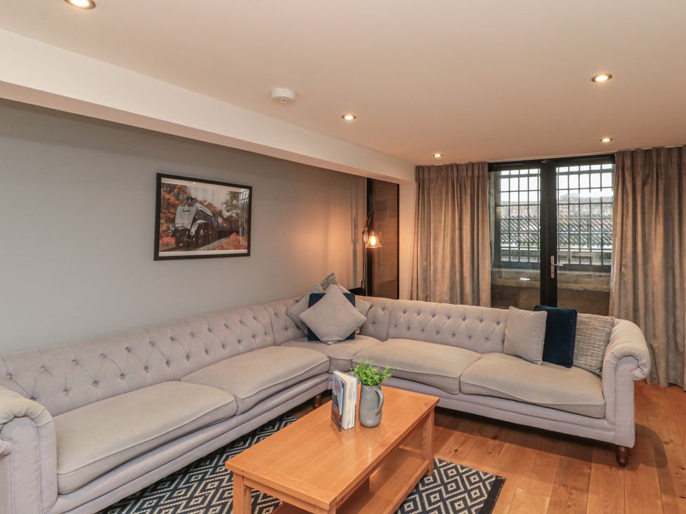 A living room with a sofa and coffee table at Sir Nigel Gresley @ Engine Shed in Whitby