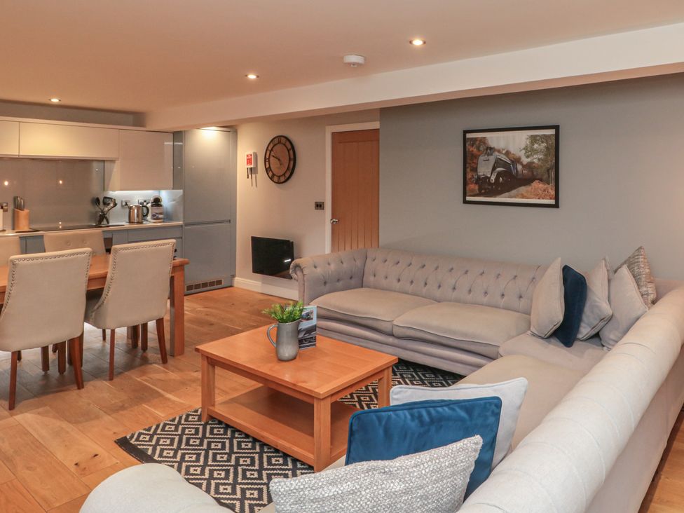 A living room with a sofa and dining area at Sir Nigel Gresley @ Engine Shed Whitby