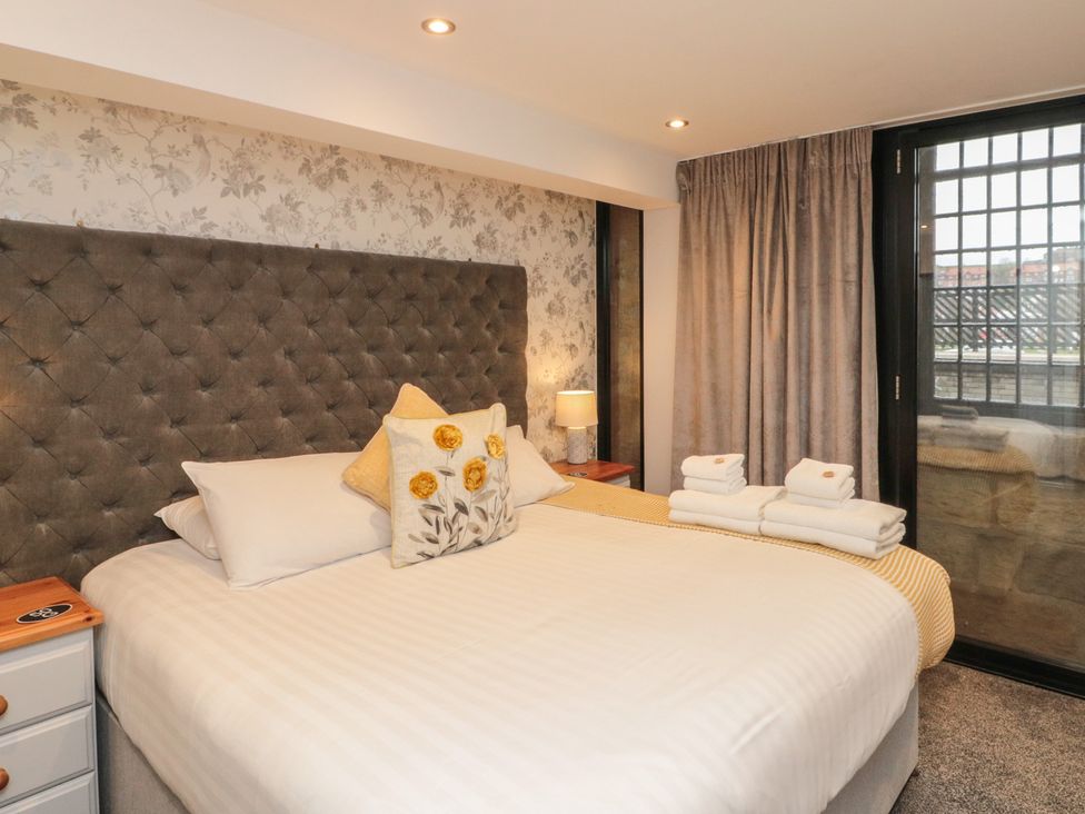 A bedroom with a bed and lamp at Sir Nigel Gresley @ Engine Shed in Whitby