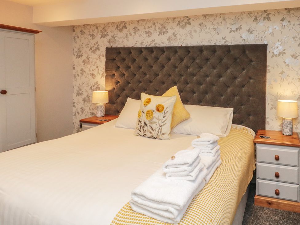 A bedroom with a bed and nightstand at Sir Nigel Gresley @ Engine Shed in Whitby