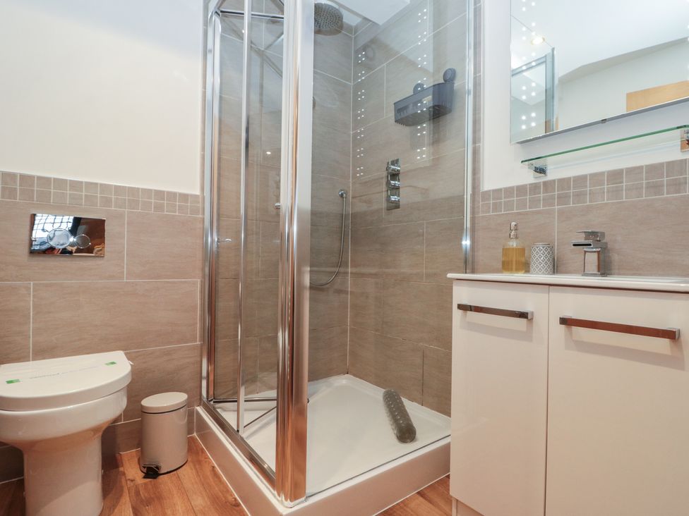 A bathroom featuring a shower, toilet, and sink at Sir Nigel Gresley @ Engine Shed in Whitby