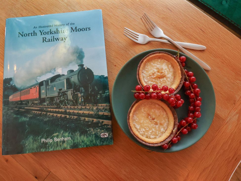 A book and a plate with two cakes and red currants at Repton @ Engine Shed Whitby