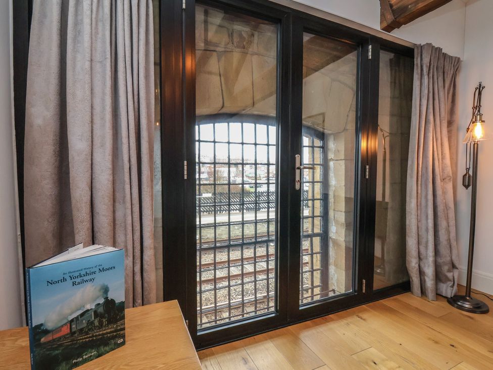 A living room with a window and a book at Repton @ Engine Shed Whitby