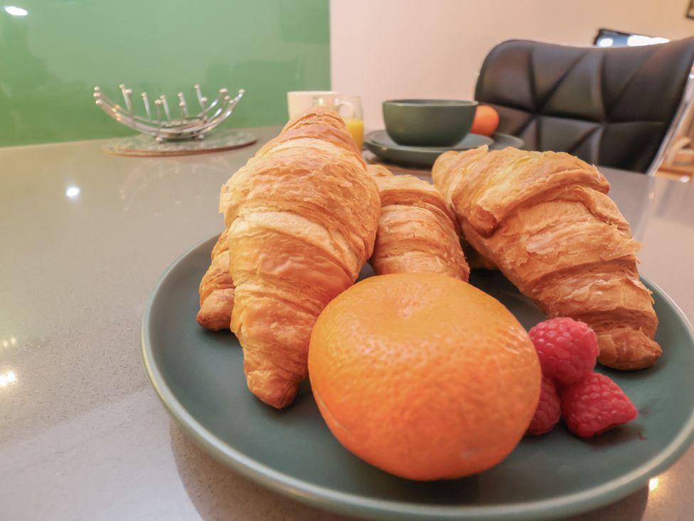 A plate with croissants, an orange and raspberries at Repton @ Engine Shed Whitby
