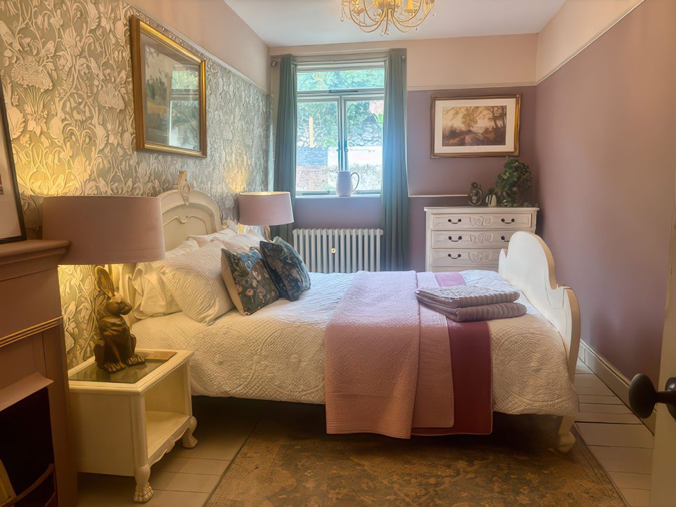 A bedroom with a bed and dresser at Liberty House Ashbourne