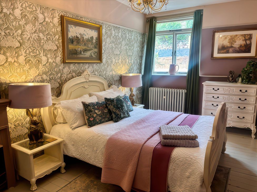 A bedroom with a bed and nightstand at Liberty House Ashbourne